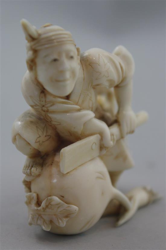 A Japanese ivory okimono of a farmer cutting a large turnip, signed Gyokushi, late 19th / early 20th century, 7cm, slight restorations